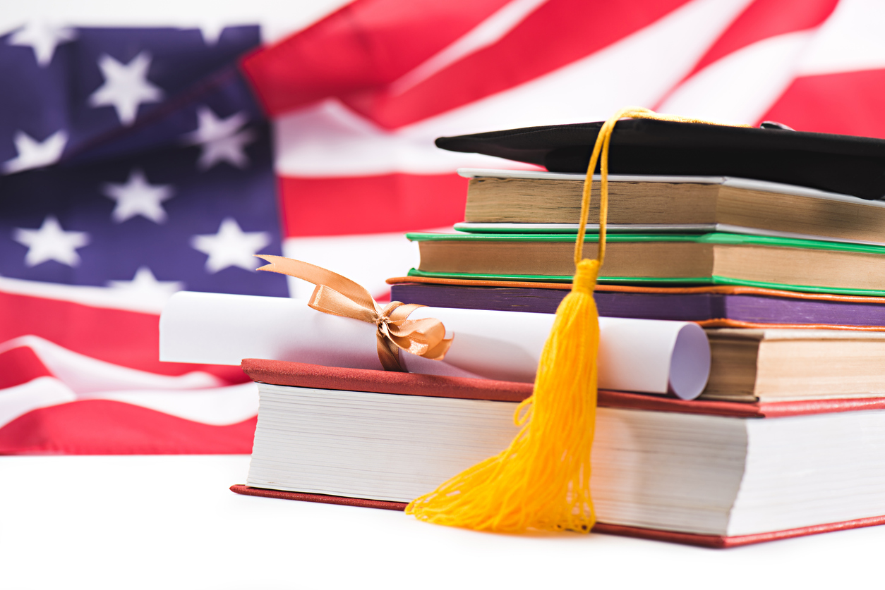 Books in front of the American flag.