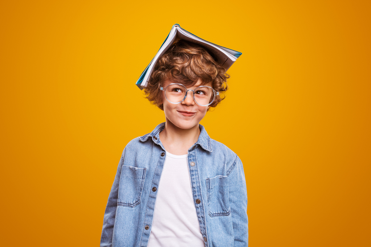 A boy with a book on his head
