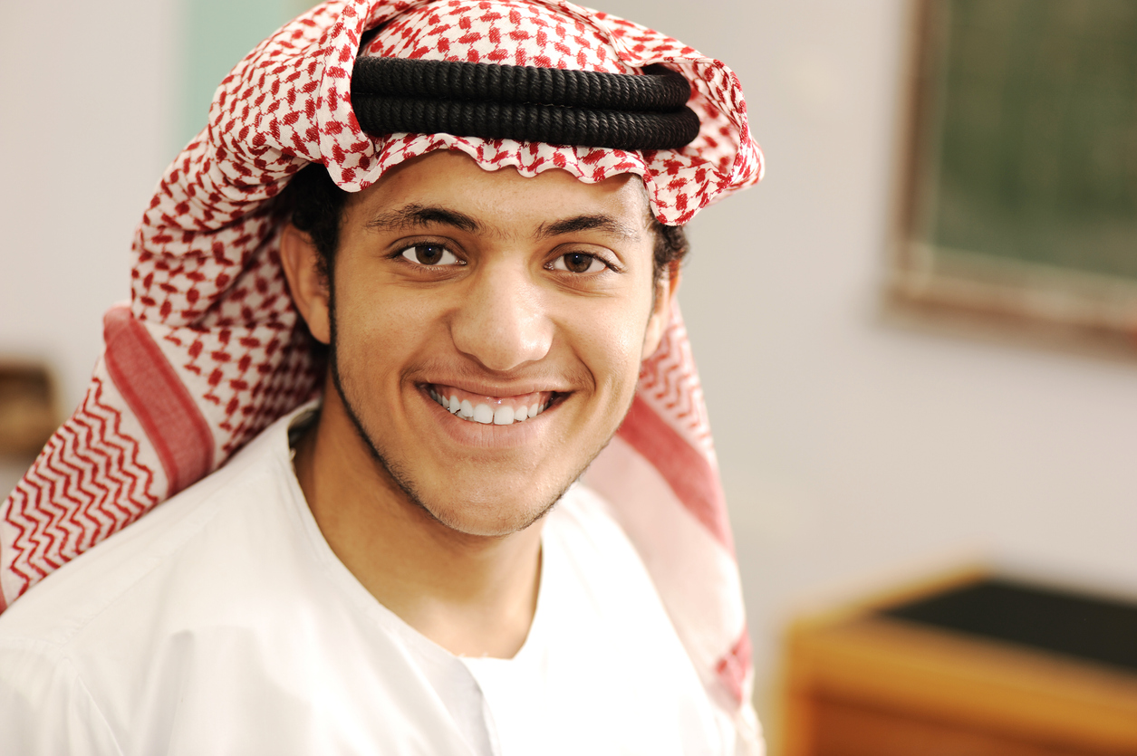 A boy in traditional united arab emirates dress.